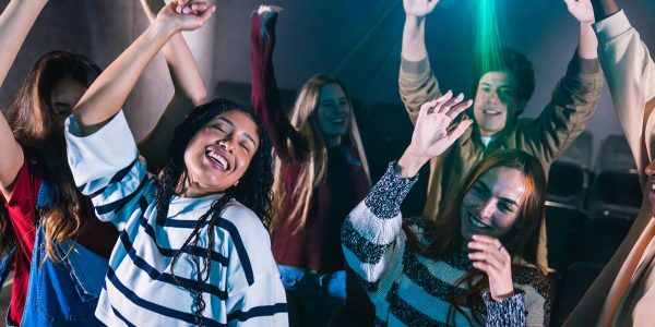 People dancing energetically at a lively party, enjoying the night.